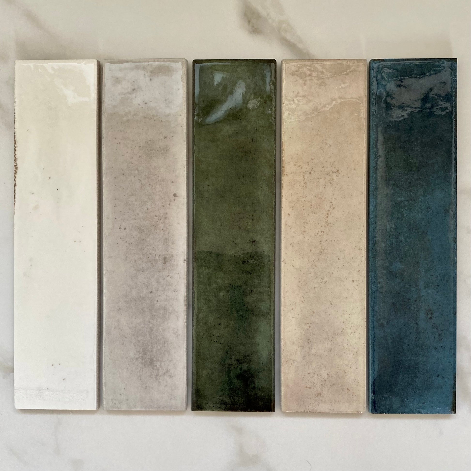 Matisse collection 2.5x8 farmhouse handmade look subway tiles in white, grey, green, cream and blue. 