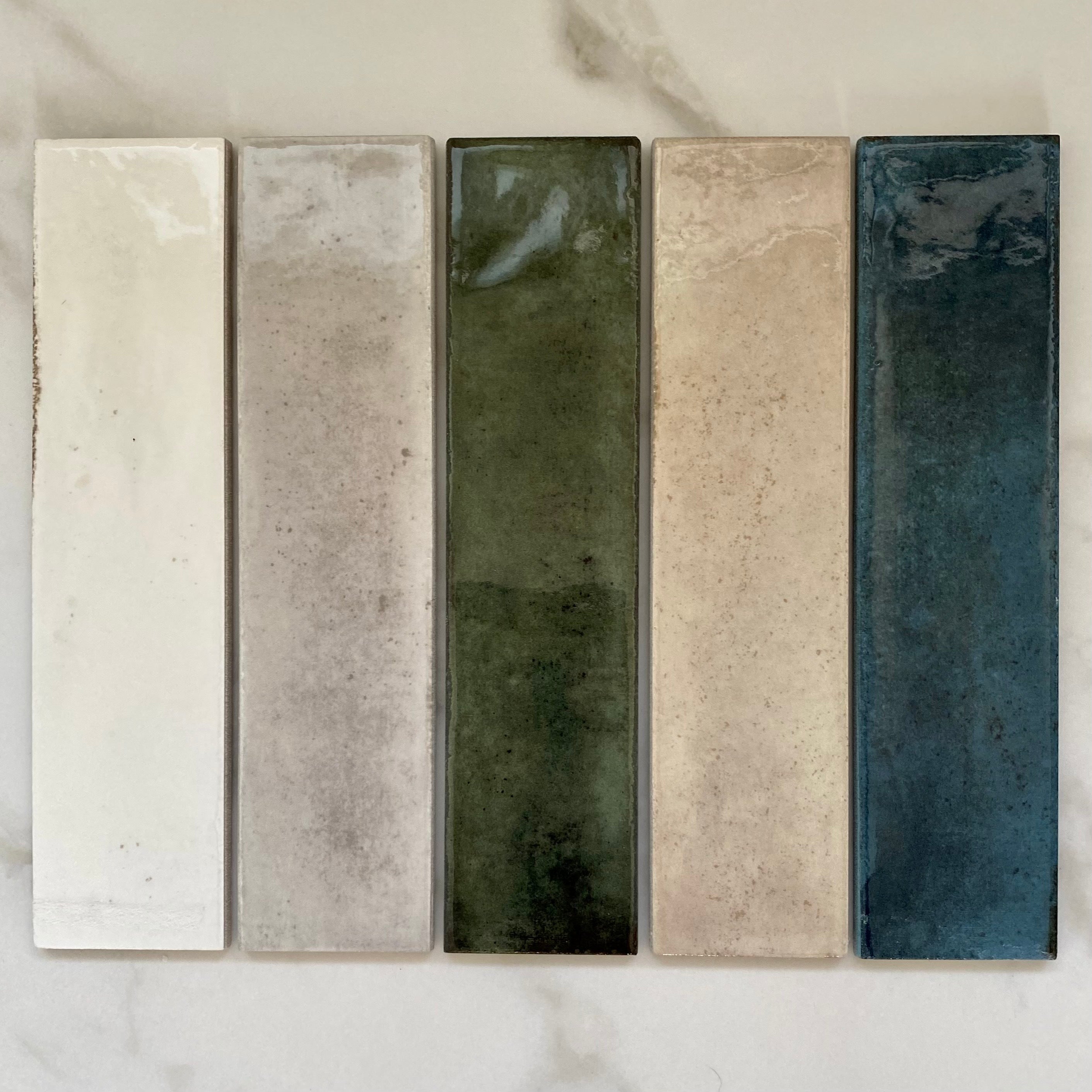 Matisse collection 2.5x8 farmhouse handmade look subway tiles in white, grey, green, cream and blue. 