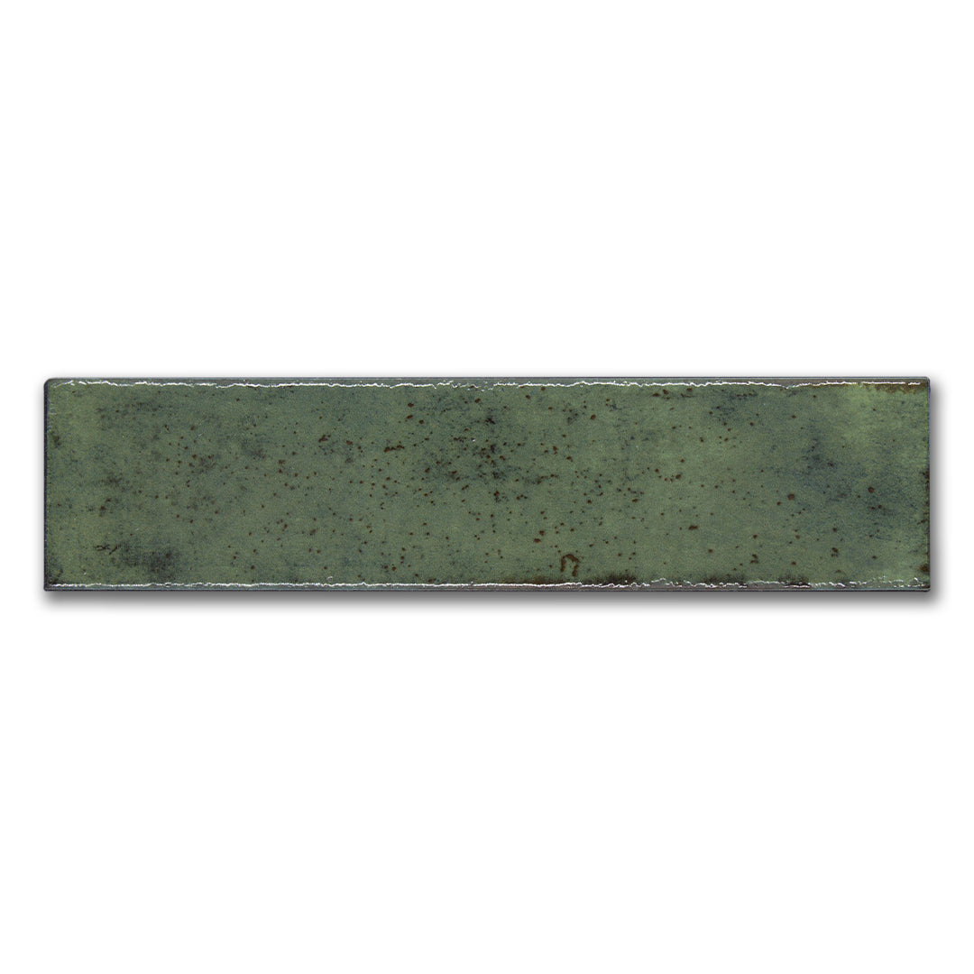 A single matisse green 2.5x8 handmade speckled subway tile. 
