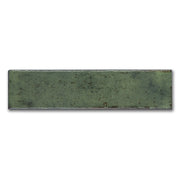 A single matisse green 2.5x8 handmade speckled subway tile. 