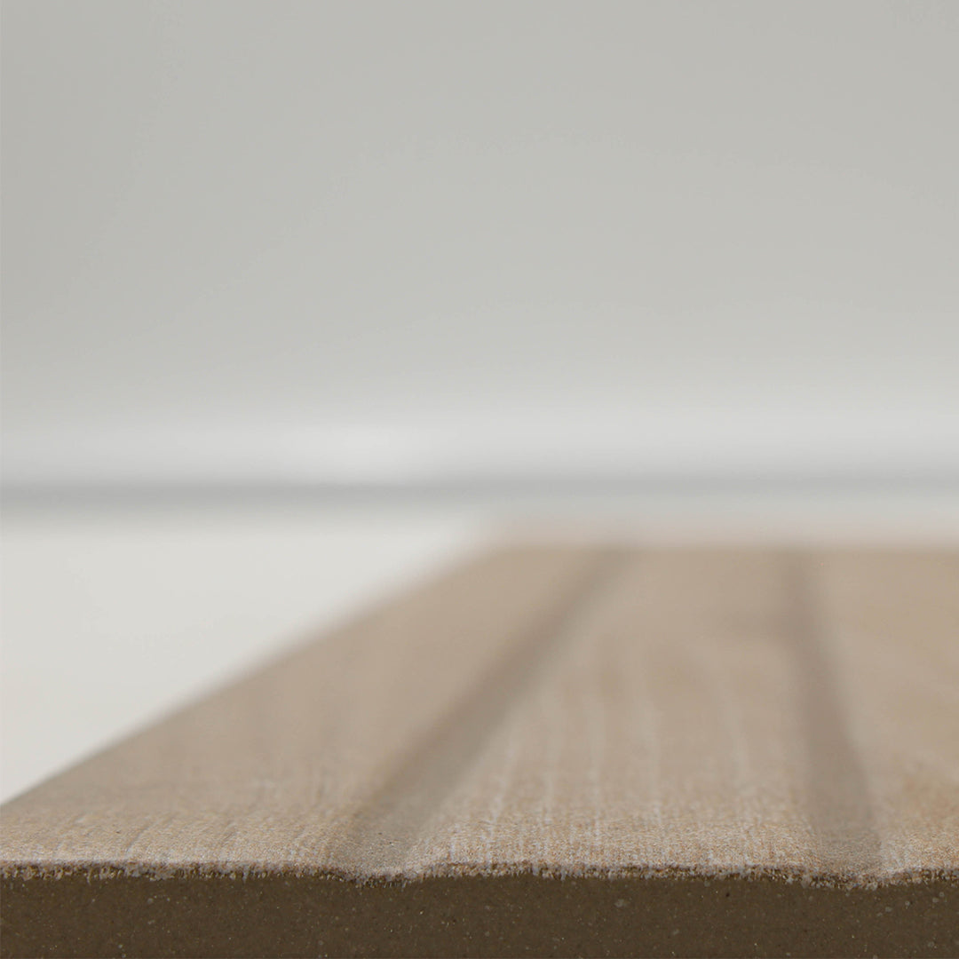 Angled close up of the Tangram Oak to highlight the very slight grooves in the faux grout line of the geometric pattern on the surface of the tile. Easy to clean and no deeper than regular grout lines. 