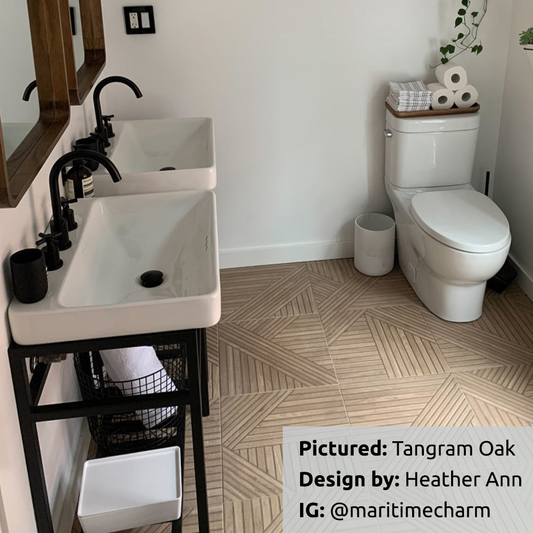 Tangram Oak Wood-Look Porcelain Tile installed in a modern bathroom with black and white accessories. Tile by TilesINspired and Realonda. Available to buy online across Canada